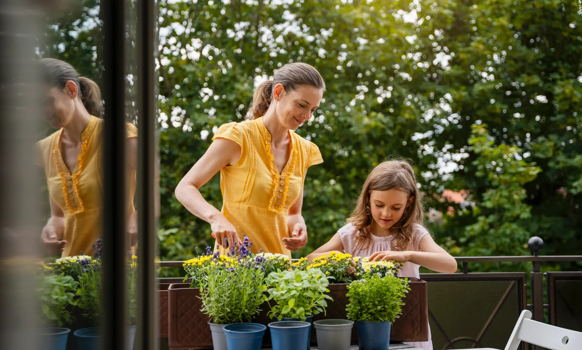 Mutter mit Tochter bei der Kräuterpflege